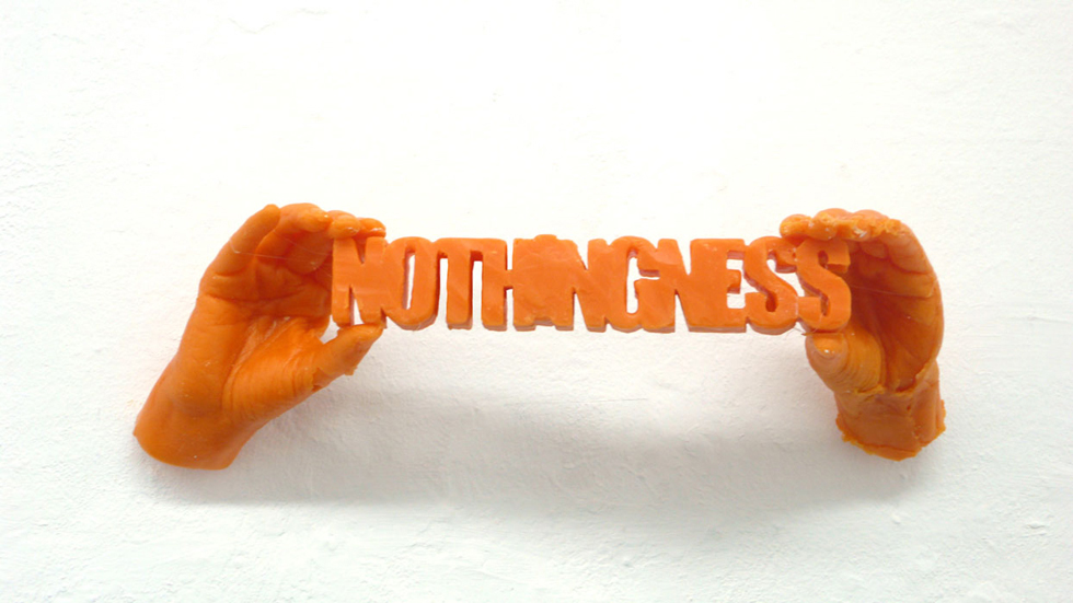 Two wax cast hands hold the word nothingness